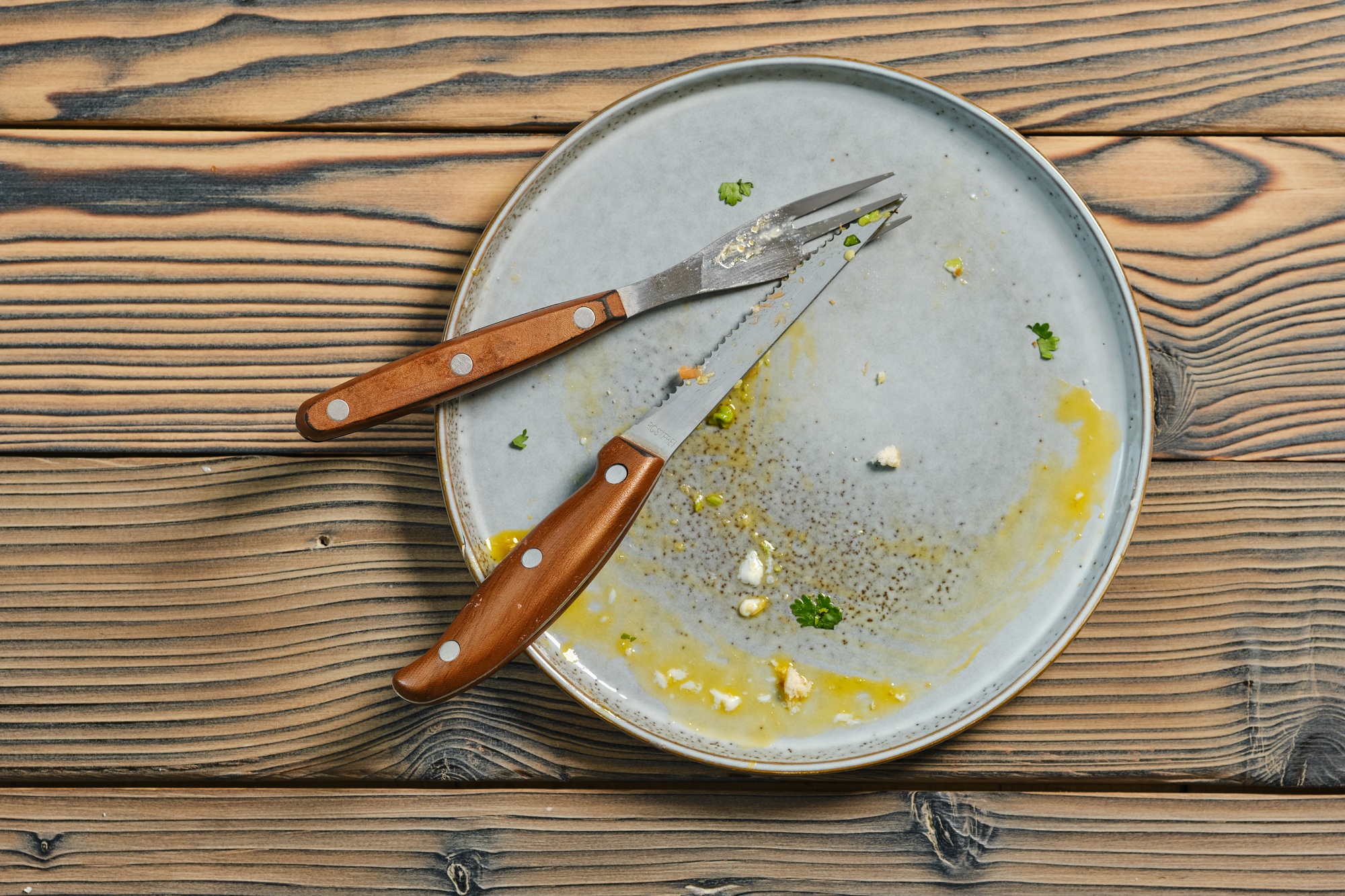 Overhead view of empty dirty plate on a table