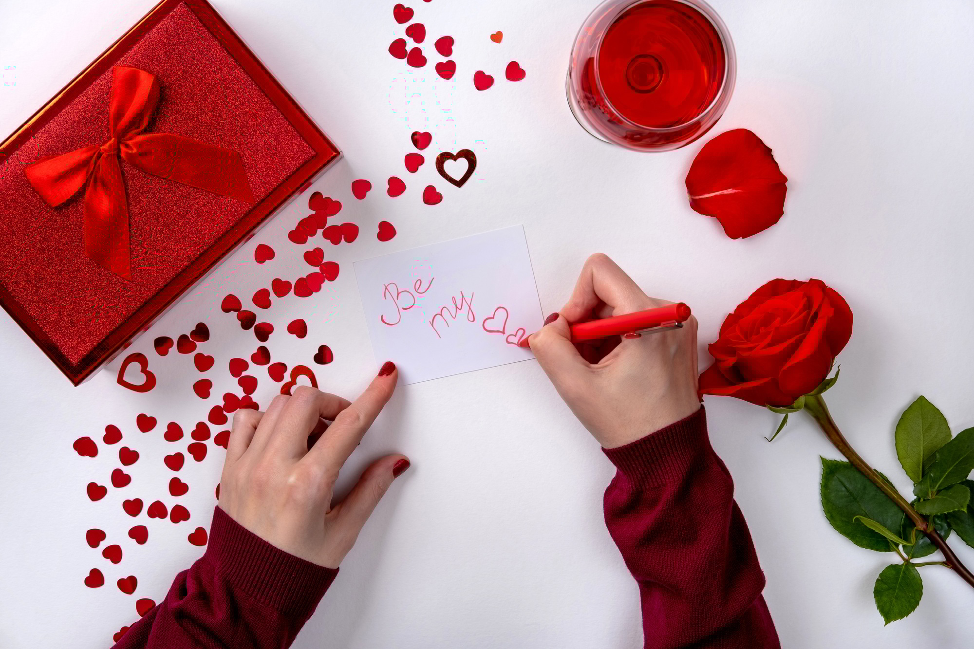 Woman writing love letter for Valentines day.